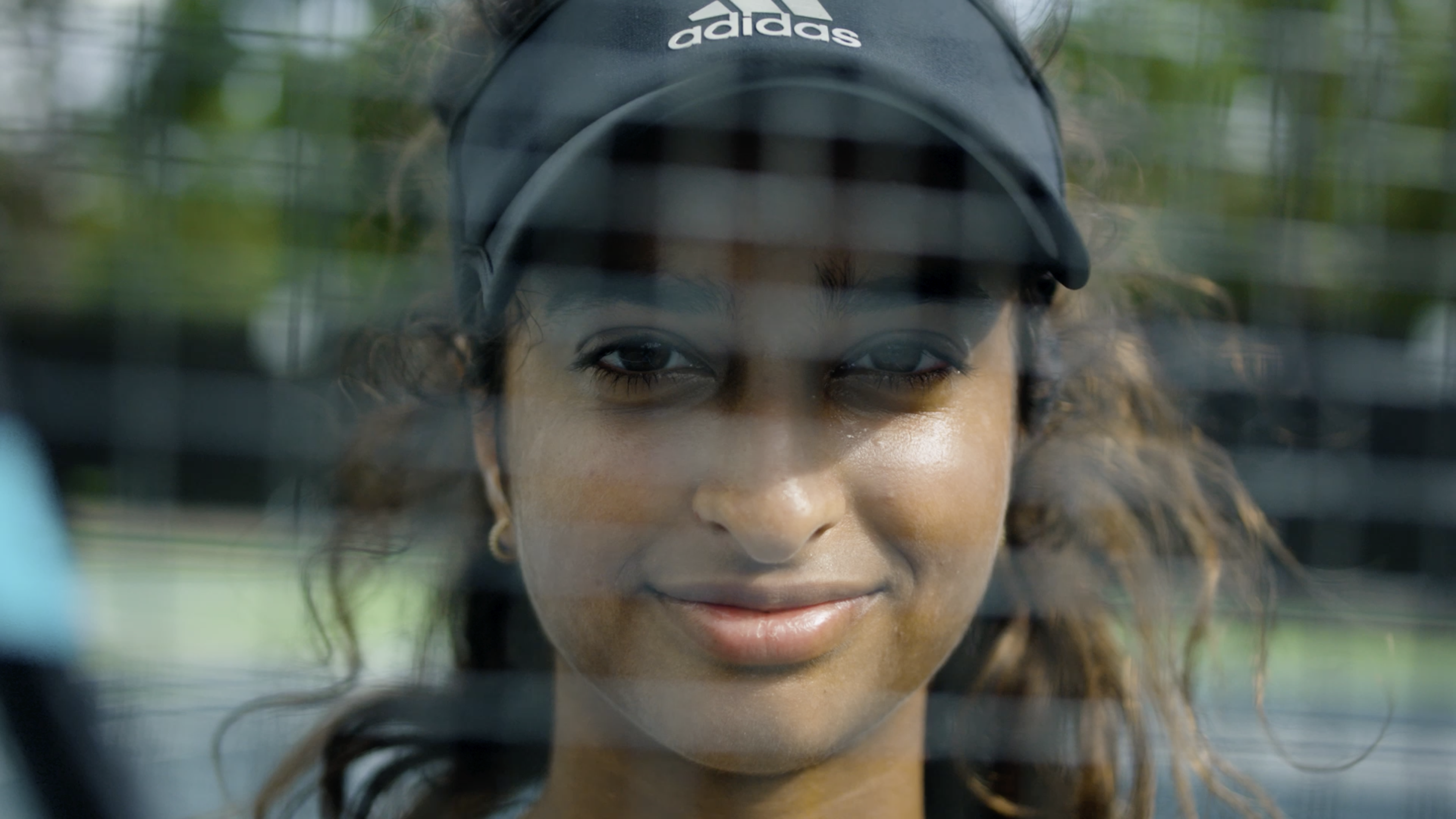 Tennis player through net